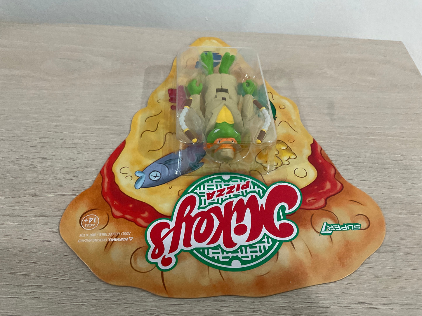 Super7 ReAction Teenage Mutant Ninja Turtles – Undercover Michelangelo “Weird Pizza To Go” 3.75-Inch Figure