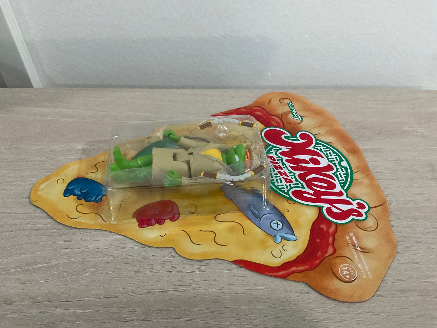 Super7 ReAction Teenage Mutant Ninja Turtles – Undercover Michelangelo “Weird Pizza To Go” 3.75-Inch Figure