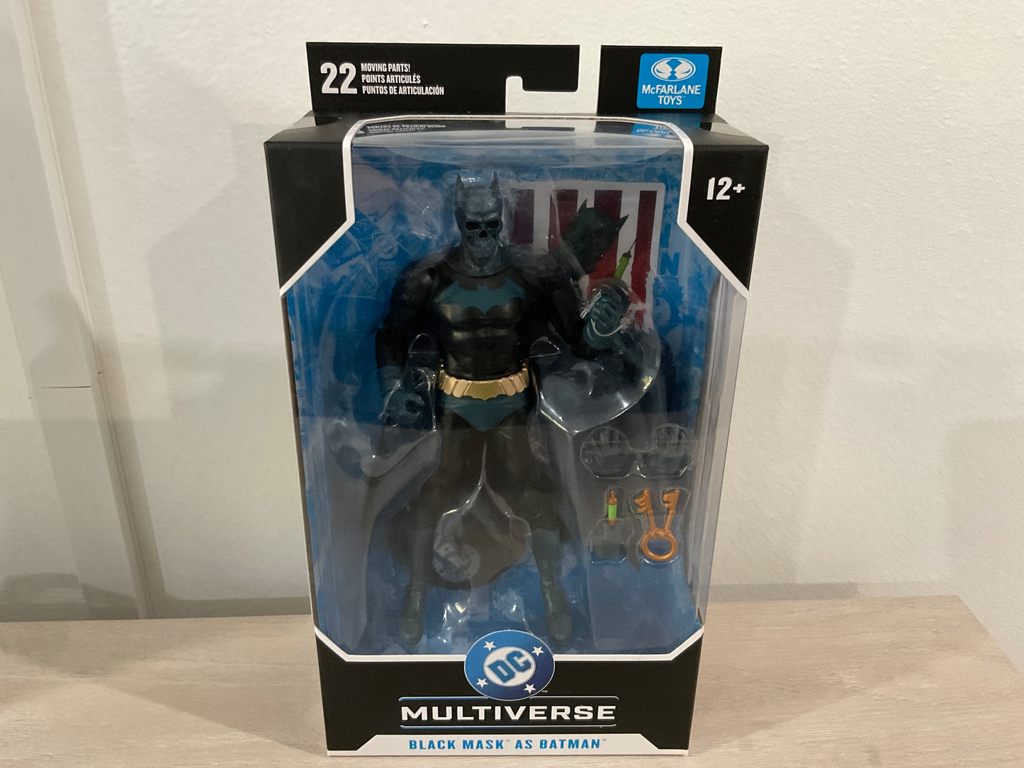 Batman action figure in packaging with Multiverse branding on a neutral background