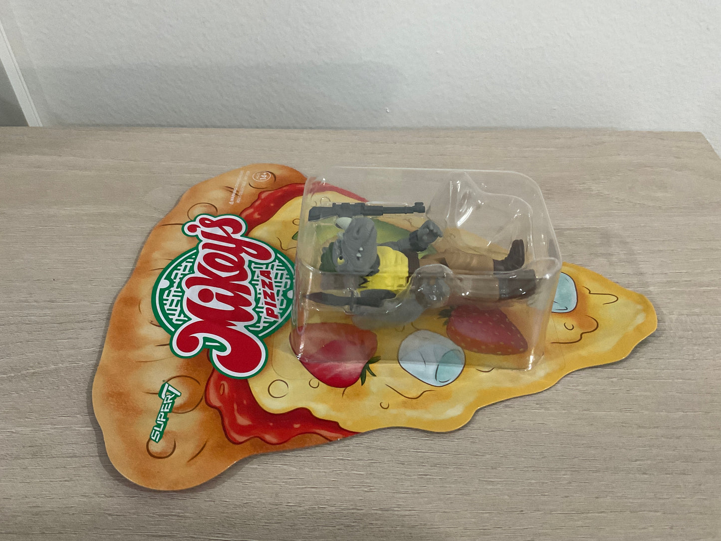 Super7 ReAction Teenage Mutant Ninja Turtles – Rocksteady “Weird Pizza To Go” 3.75-Inch Figure