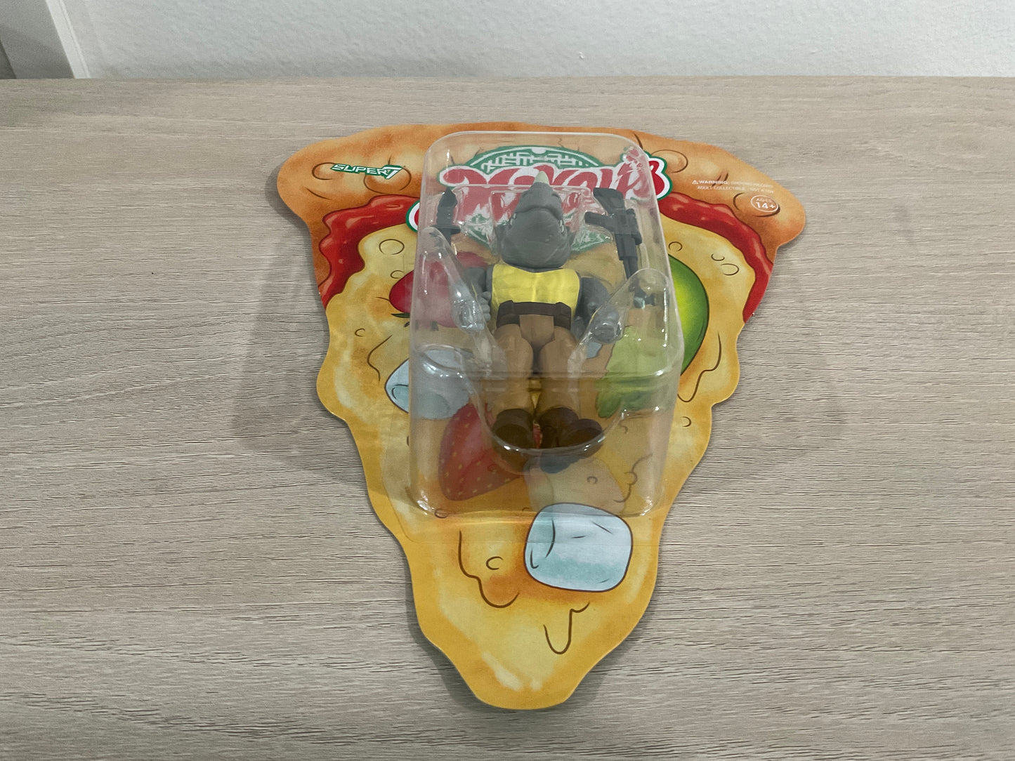 Super7 ReAction Teenage Mutant Ninja Turtles – Rocksteady “Weird Pizza To Go” 3.75-Inch Figure