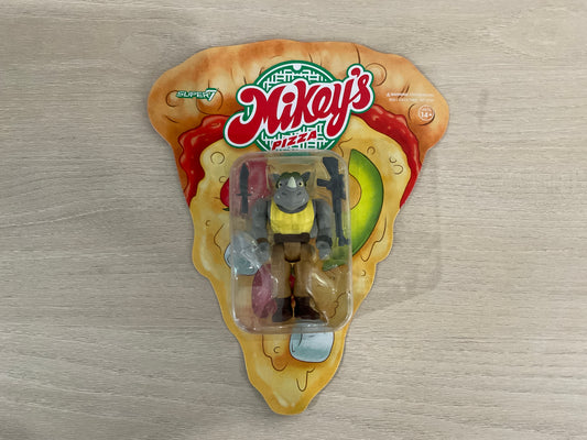 Super7 ReAction Teenage Mutant Ninja Turtles – Rocksteady “Weird Pizza To Go” 3.75-Inch Figure